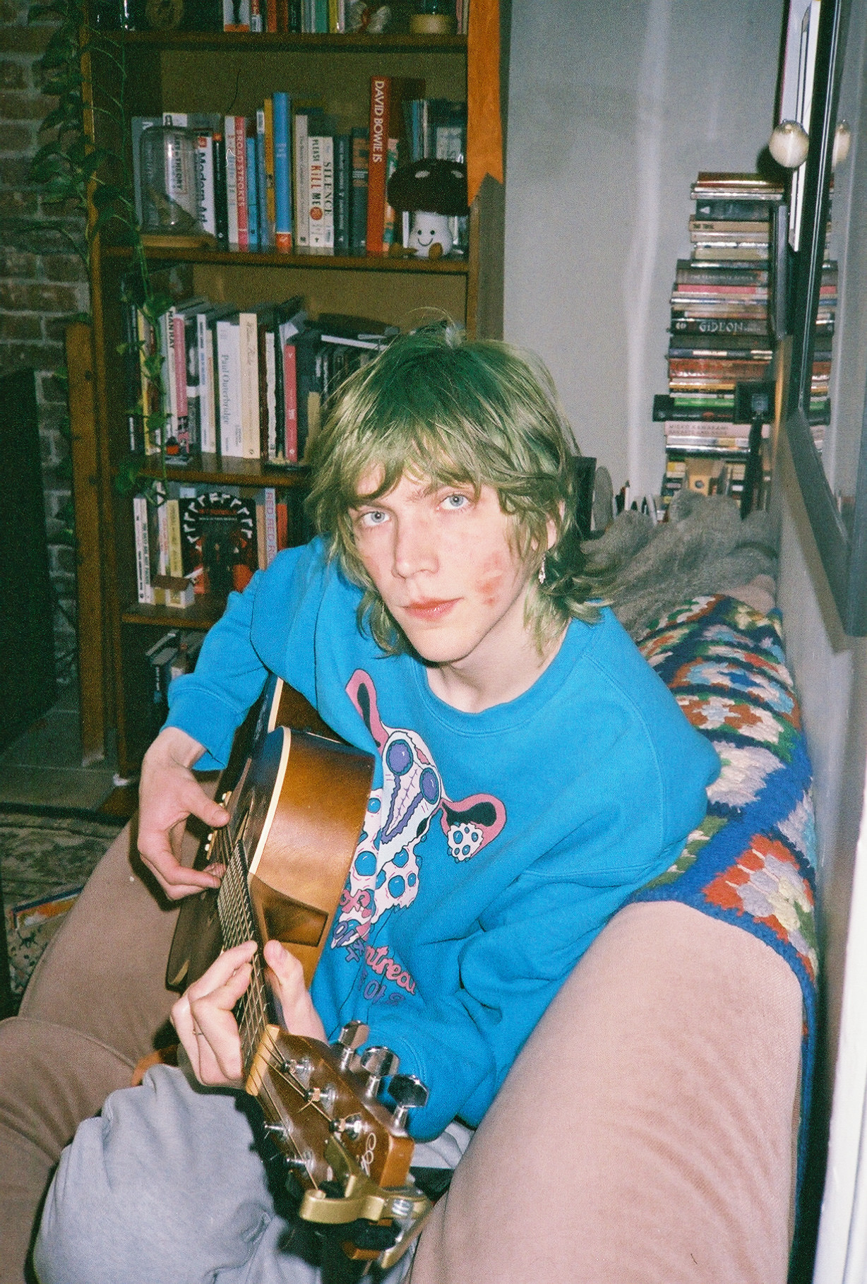 Picture of Ian holding an acoustic guitar